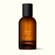 Amber glass Aesop Silently Hwyl Eau de Parfum bottle with black cap on a white background.